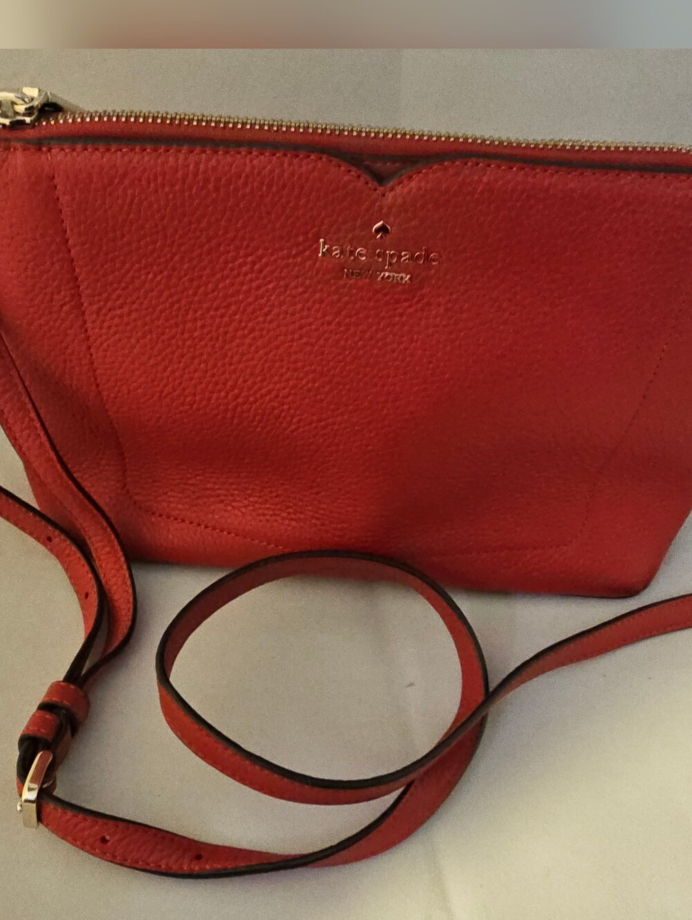 Kate Spade red pebbled leather crossbody with gold hardware